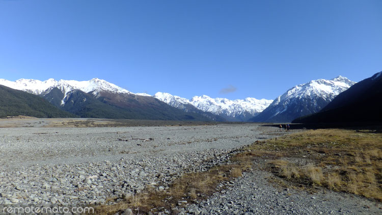 Three trampers heading up the valley